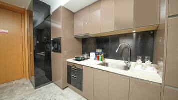 A modern kitchen with a stainless steel sink, a microwave, and a dishwasher.