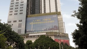 A tall building with a large advertisement on its side. - Pengman International Apartment Hotel (Guangzhou)