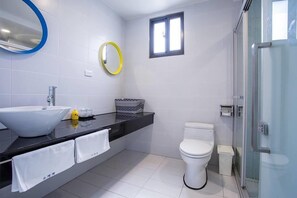 A modern bathroom with a large white sink, a toilet, and a shower area. - Hsu One One B&B (Magong)