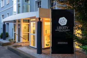 A hotel entrance with a modern design, a signboard, and a visible reception area. - Arthotel ANA Liberty, Trademark Collection by Wyndham (Bremen)