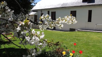 Un bâtiment blanc doté d’un toit en pente et de nombreuses fenêtres.