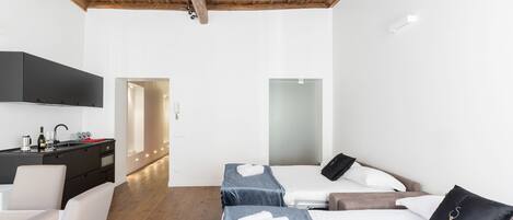 Apartment, 1 Bedroom | Desk, laptop workspace, iron/ironing board, cribs/infant beds