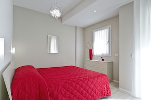 A bedroom with a bed, a dresser, a mirror, and a window. - Residence Armony Misano (Misano Adriatico)