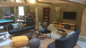 A cozy living room with a pool table, sofas, and a bookshelf. - Adventure Park Apartments (Ringkobing)