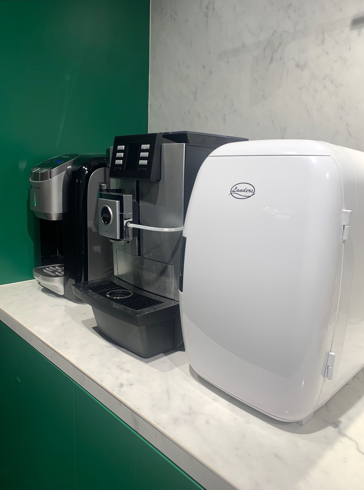 Una cafetera con pantalla digital y un logotipo de la marca en la parte frontal.