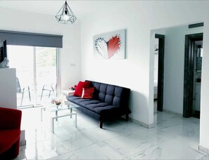 Deluxe Suite, 2 Bedrooms | Living room | Flat-screen TV, fireplace