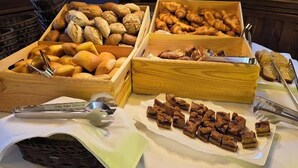 A buffet table with various baked goods and pastries. - Hotel Adler Bärental (Feldberg)