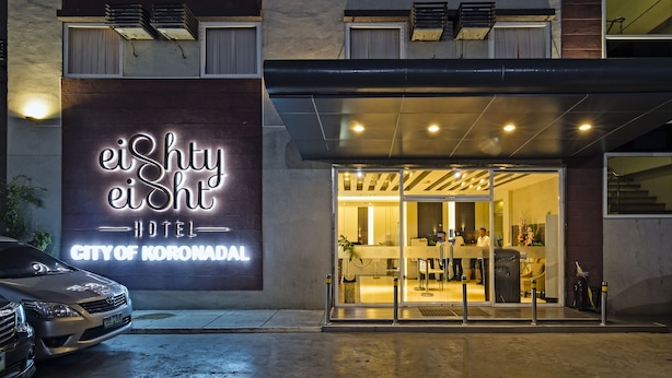 The exterior of the eiShifty Hotel in the City of Koronadal, featuring a large illuminated sign, a glass entrance, and a modern design. - Eighty Eight Hotel (Koronadal)