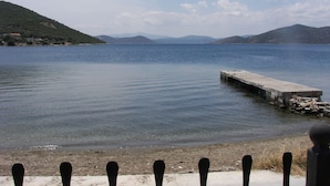 Un lago tranquilo con un muelle de hormigón que se adentra en el agua.
