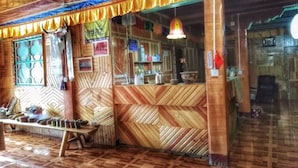 A wooden interior with a counter and seating area.