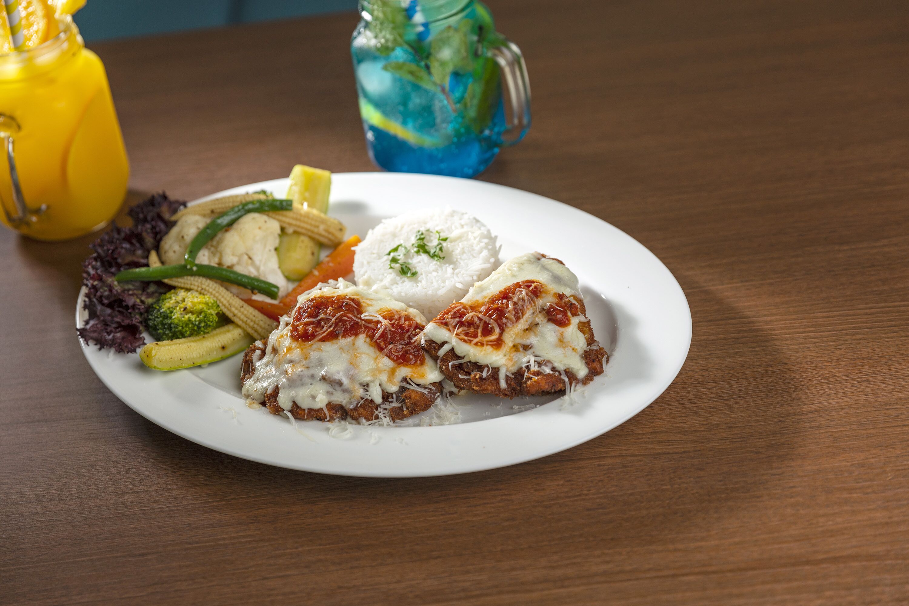 A plate of food with a white plate on a wooden table.