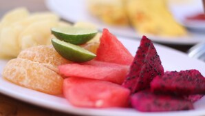 A plate with sliced fruits including watermelon, dragon fruit, and mango. - Putra Bali Villa (Penida Island)