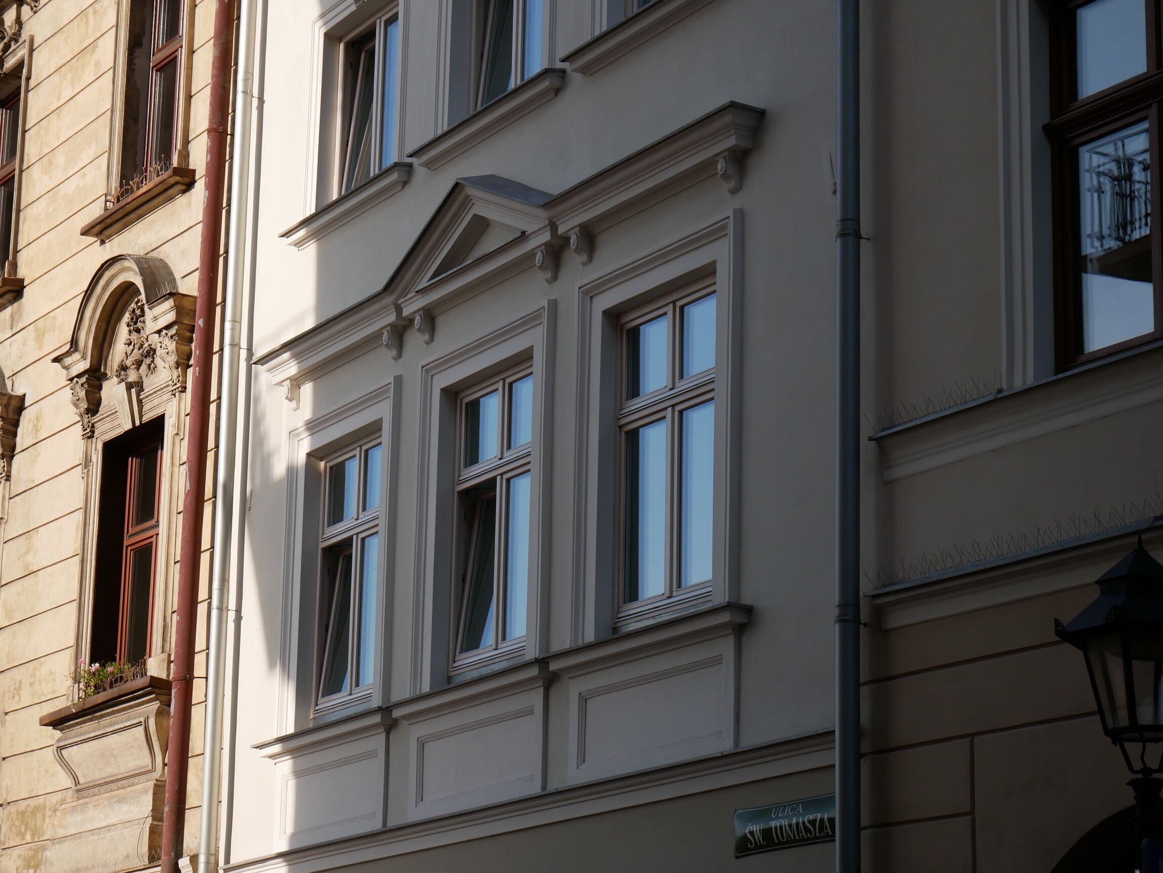 A building facade with classical architectural details, including ornate window frames and decorative moldings.