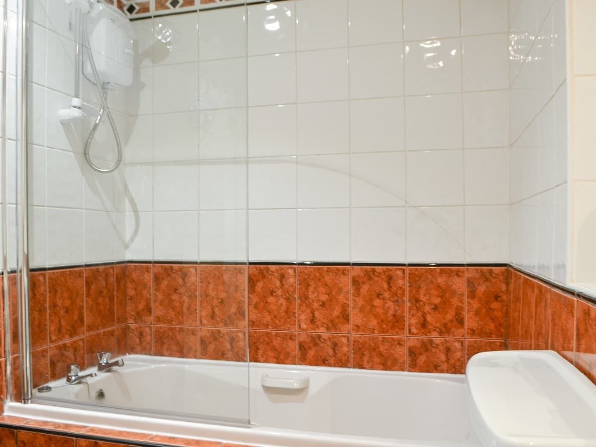 A bathroom with a bathtub, a shower, and a toilet.