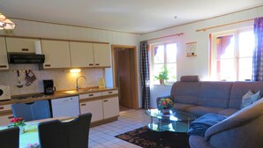 A compact living space with a kitchen, dining area, and seating area.