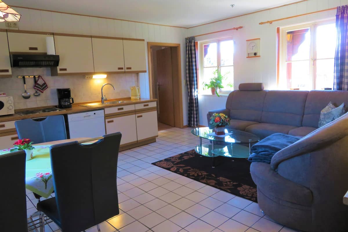 A compact living space with a kitchen, dining area, and seating area.