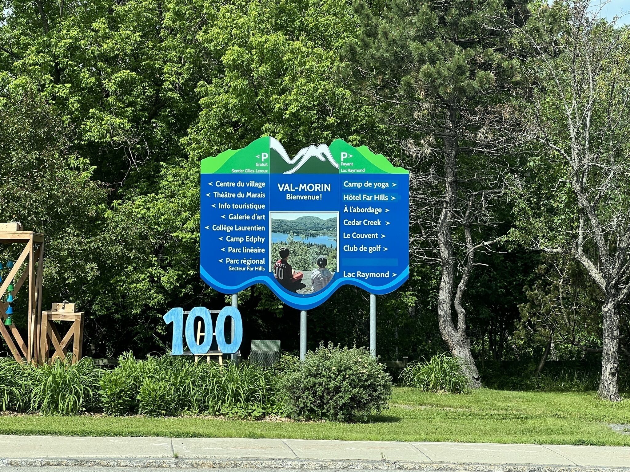 A sign with a map and a large '100' indicating a location.