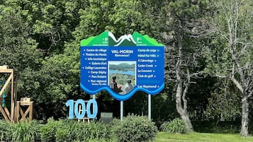 A sign with a map and a large '100' indicating a location.