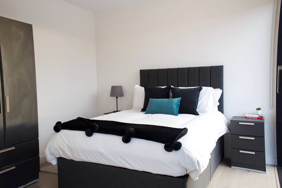 Hypo-allergenic bedding, desk, laptop workspace, blackout curtains