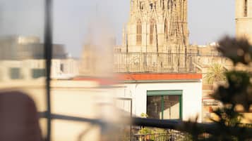 A view of a cathedral with intricate architecture, a small building in the foreground, and a clear sky.