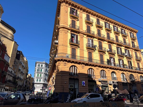 A multi-story building with a classic architectural style, featuring ornate balconies and large windows. - Umberto Primo Suite e Spa (Naples)