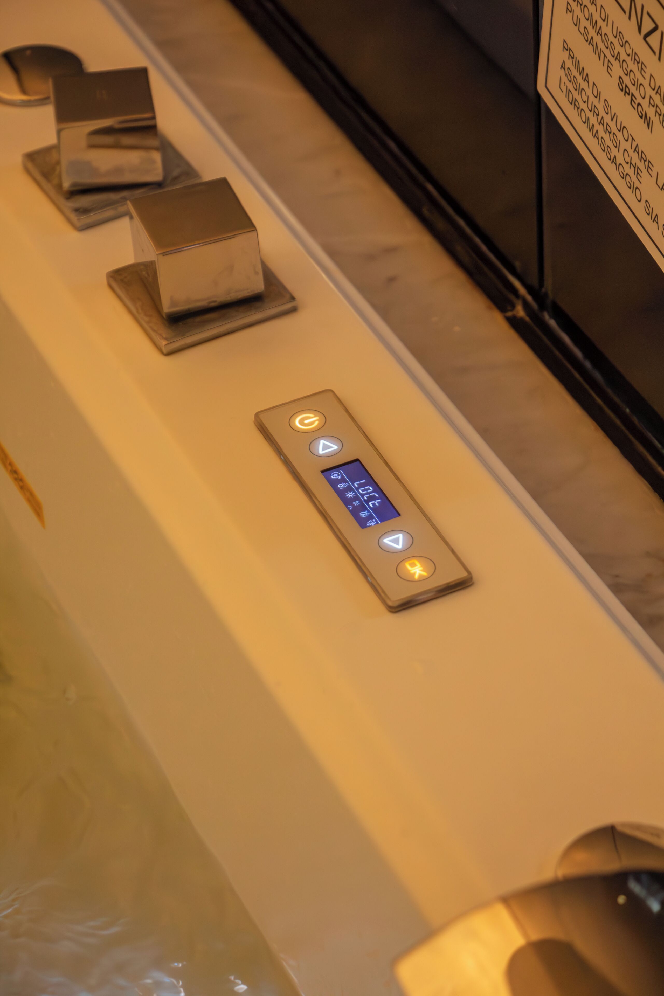 An elevator control panel with a digital display and buttons.