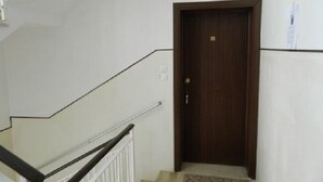 A staircase with a wooden door at the bottom.