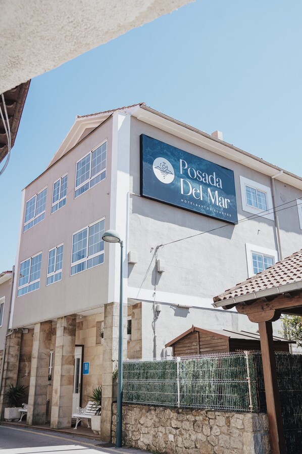 A hotel named Posada Del Mar with a sign, stone facade, and a gated entrance. - Hotel Posada del Mar (Suances)