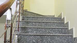 A staircase with granite steps and a wooden handrail. - Duc Thang Guest House (Dien Bien Phu)