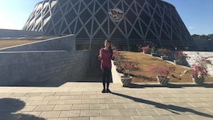 A large, modern building with a geometric facade and a circular emblem. - Duc Thang Guest House (Dien Bien Phu)