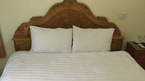 A bed with a white bedspread, two pillows, and a decorative quilt. - Duc Thang Guest House (Dien Bien Phu)