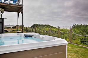 Relax in a serene outdoor setting surrounded by lush greenery and a deck.