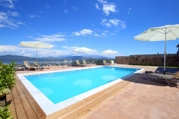 Seasonal outdoor pool, pool umbrellas, pool loungers