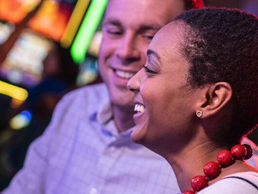 A person playing a video game at a gaming arcade.