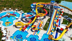 A water park with multiple slides and pools, surrounded by lounge areas and umbrellas. - Avcilar Elit Hotel (Istanbul)
