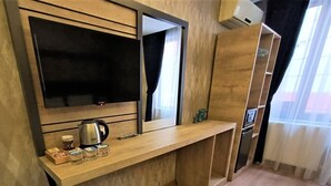A modern kitchenette with a built-in microwave, kettle, and coffee maker. - Avcilar Elit Hotel (Istanbul)