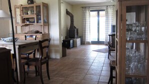 A spacious kitchen with a dining area, a built-in stove, and a cabinet with glass doors. - Villa Mary near Rovinj (Rovinj)