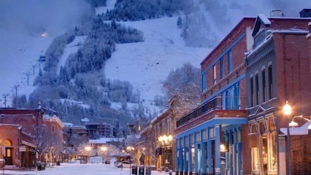 A snow-covered town with historic buildings and a mountain in the background. - Aspen Ritz Carlton 3 Bed (Aspen)