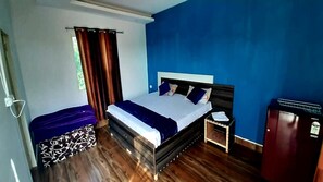 A bedroom with a bed, a nightstand, a dresser, and a window with curtains. - OVER NIGHT STAY ARAVALI ADVENTURE, GURGAON DELHI NCR (Gurugram)