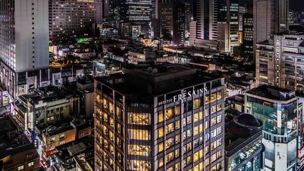 A high-rise hotel with multiple floors, a prominent entrance, and a well-lit facade. - Sotetsu Fresa Inn Seoul Myeong Dong (Seoul)