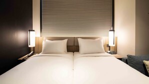 A double bed with a headboard, bedside lamps, and a nightstand with a phone. - Sotetsu Fresa Inn Seoul Myeong Dong (Seoul)