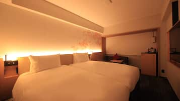 Una habitación de hotel con una cama grande, mesitas de noche, un escritorio y un televisor.