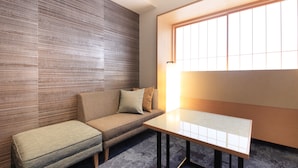 A modern room with a sofa, bench, and a table.