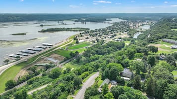 An aerial view of a residential area with houses, roads, and a large body of water.