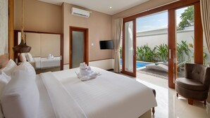 A hotel room with a bed, a TV, a chair, and a view of a swimming pool.