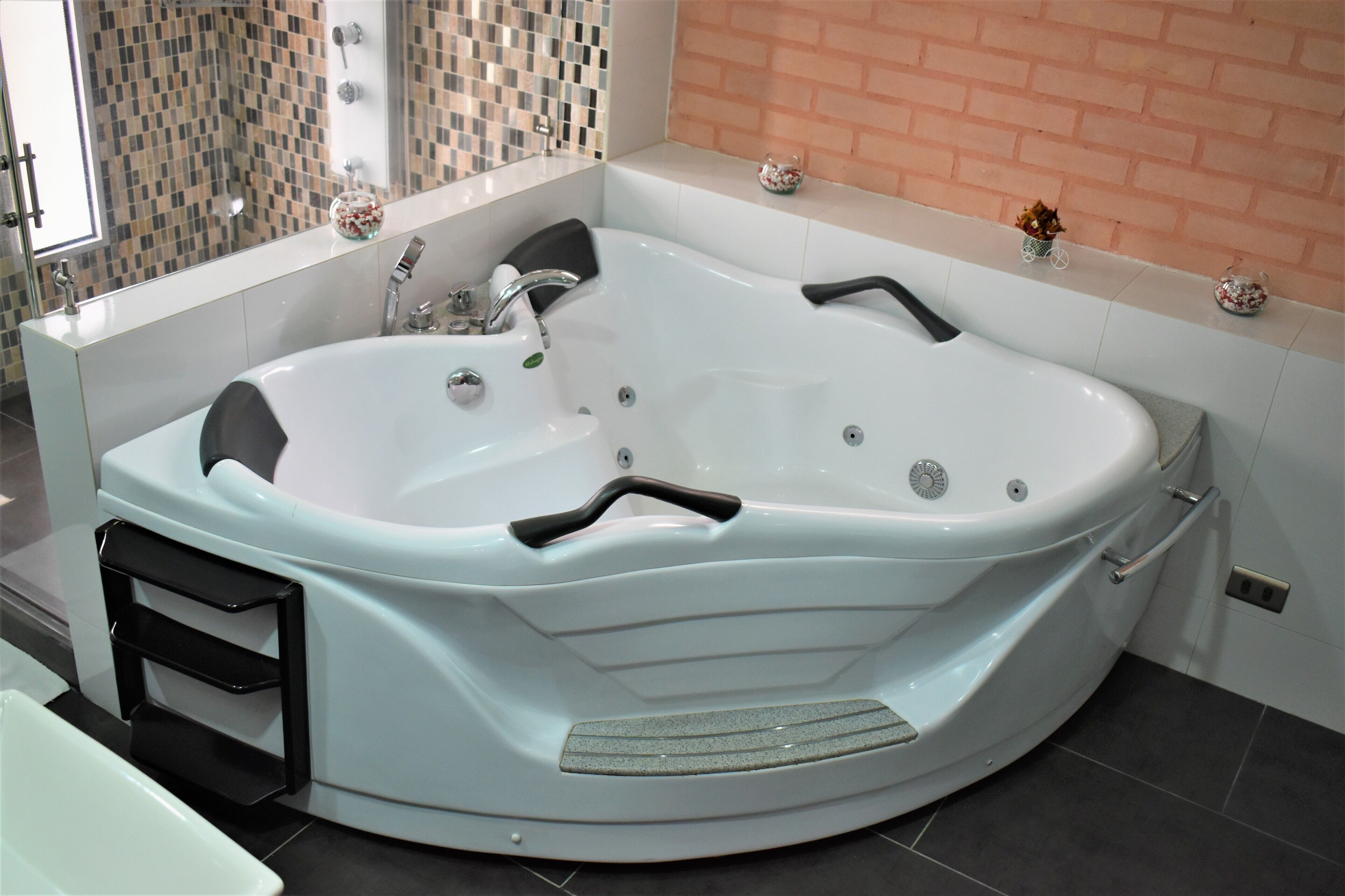 A modern bathroom with a freestanding bathtub, a glass shower enclosure, and a tiled shower area.