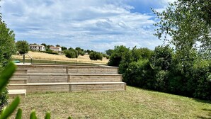 A wooden staircase leading up to a building, surrounded by a grassy area and trees. - N084 - Numana, villa with garden and pool (Numana)