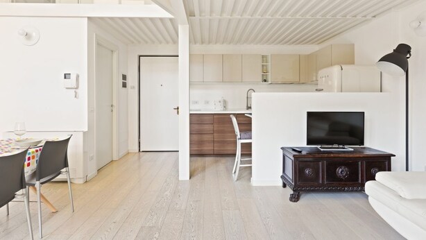 A modern interior with a dining area, kitchen, and living space. - GuestHost - NEW! Exclusive Loft with balcony & garden! (Milano)