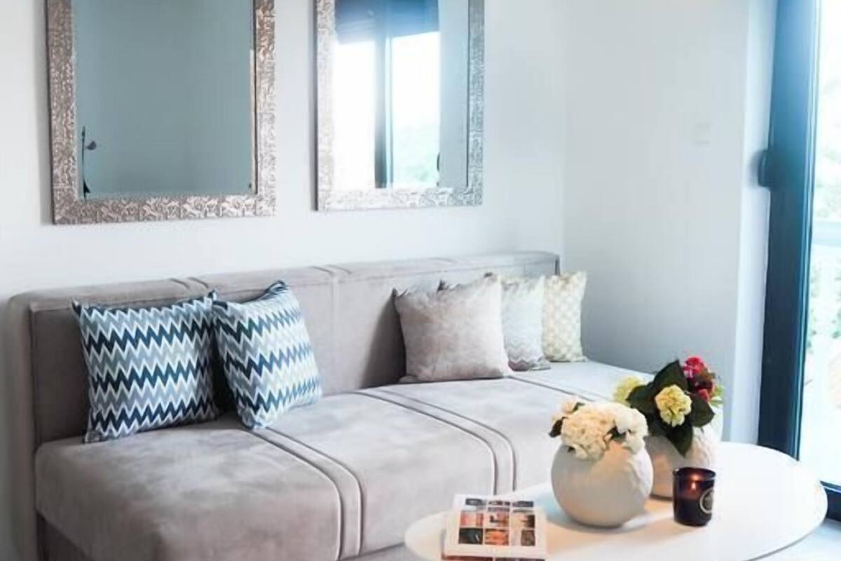 A modern living room with a sofa, a coffee table, and decorative items.