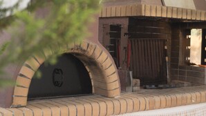 A brick oven structure with a door and a small step leading up to it. - Sofia's Residence by Estia (Heraklion)